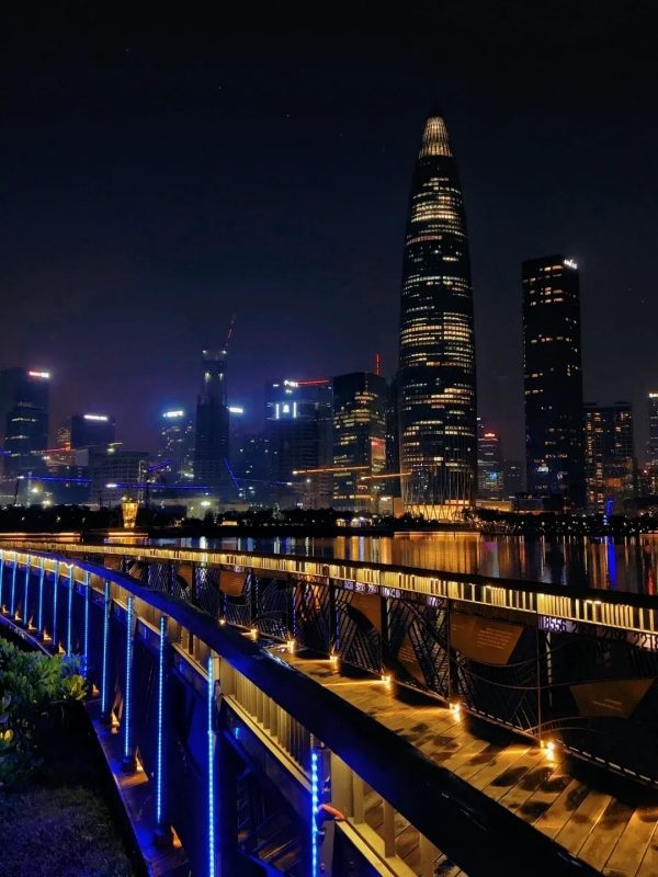 Lit Waterfront Bridge with City Skyline ReflectionLit Waterfront Bridge with City Skyline Reflection