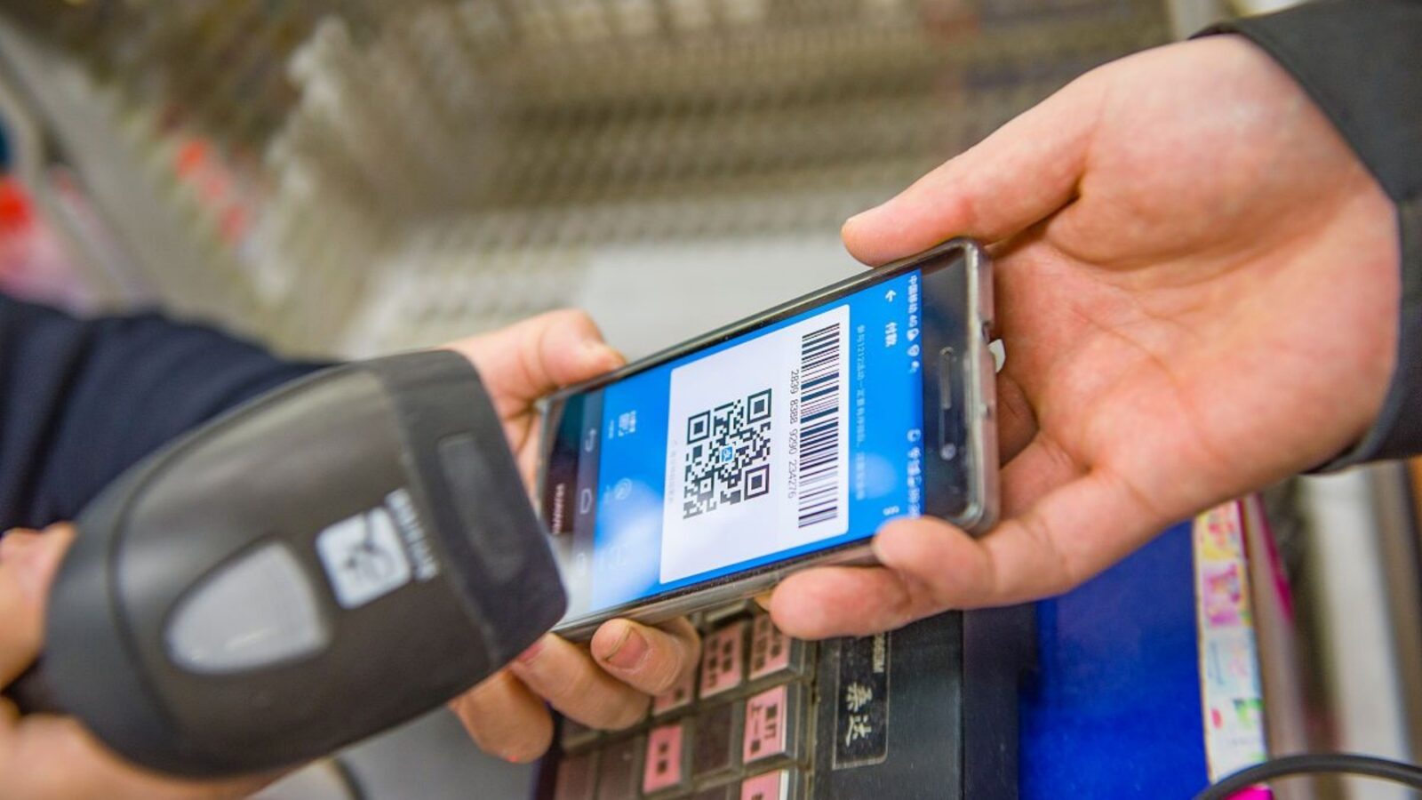 Cashier Scanning Alipay Payment QR Code At Retail Checkout